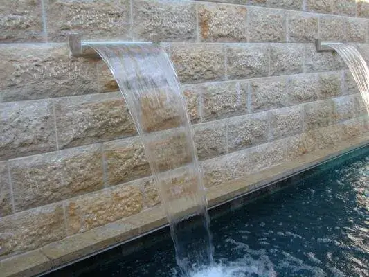 Split-Face Limestone Waterfall Golden split face limestone brick is the perfect back drop to this cascading waterfall.